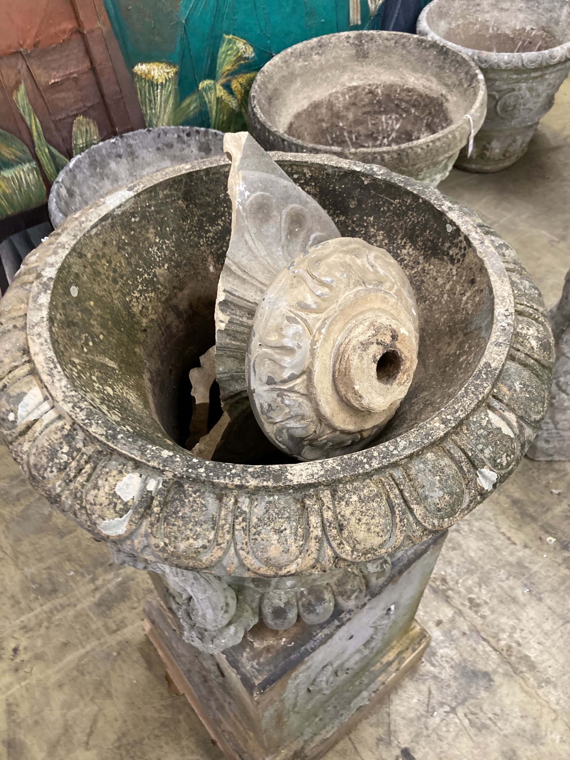 A painted earthenware campana garden urn on square plinth, (in need of repair) 53cm diameter, height 100cm